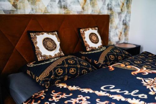 a bed with a blue comforter and pillows on it at AH Designe in Košice
