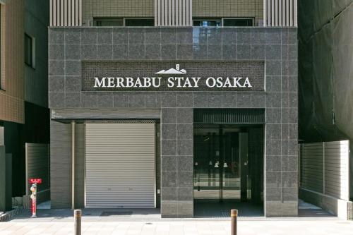 a meebustay oasis sign on the front of a building at MERBABU STAY OSAKA in Osaka
