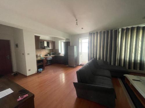 a living room with a couch and a kitchen at Your comfort is our responsibility in Ulaanbaatar