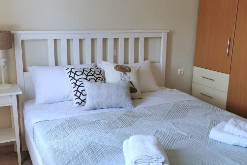 a bedroom with a white bed with pillows at The Baker's Delight in Kýthira