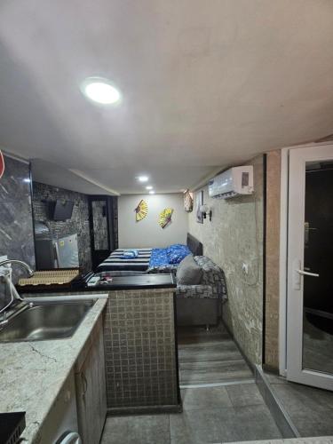 a small kitchen with a bed in a room at Beqa house in Tbilisi City