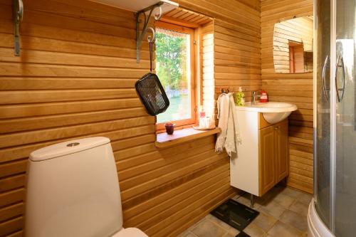 a bathroom with a toilet and a sink at Log house with a sauna and hot tub in Atla! in Atla