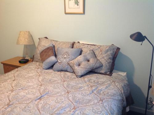 a bed with pillows on it in a bedroom at A Suite Alaskan Inn in Fairbanks