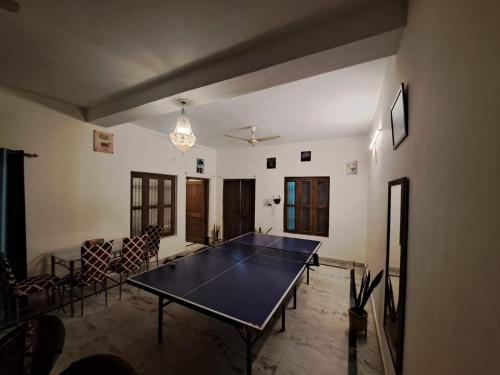 a dining room with a ping pong table in a room at Jasmine Stay by Walias in Gurgaon