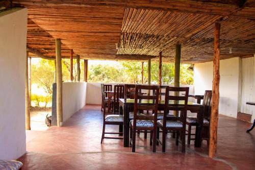 a dining room with a table and chairs at Mara Forest camp in Keekorok