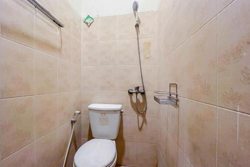 uma casa de banho com um WC e um chuveiro em RedDoorz At Graha 99 Simomulyo em Surabaya