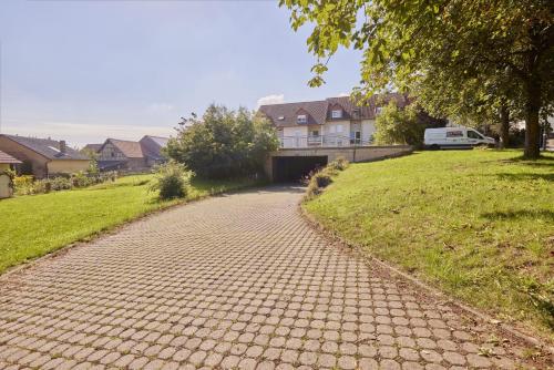 a cobblestone road in a residential neighborhood with a house at Imma - im idyllischen Walldürn-Glashofen in Walldürn