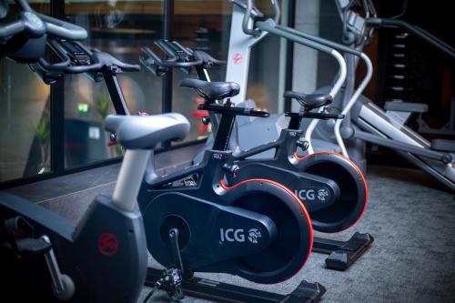 a row of exercise bikes in a gym at Hotel Meta Resort & Vine SPA in Szczyrk