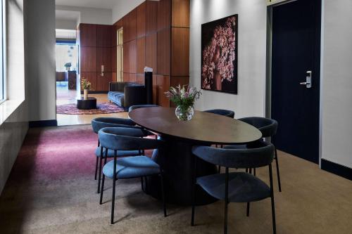 a meeting room with a table and chairs at Adina Apartment Hotel Melbourne Flinders Street in Melbourne