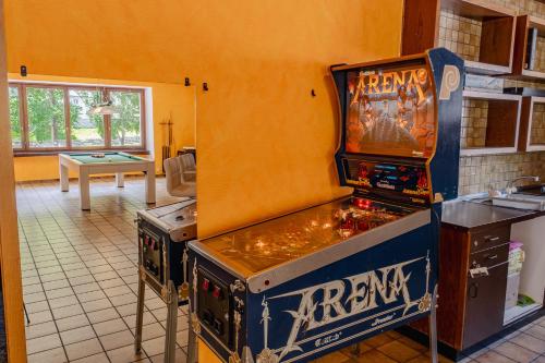 a video game machine in a kitchen next to a room at Lizard House in Cevio