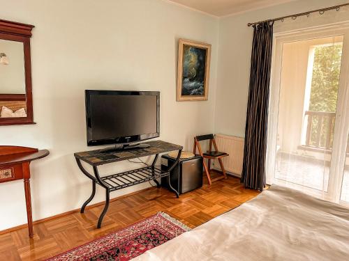 a living room with a television and a table with a tv at Casa Miu in Sinaia