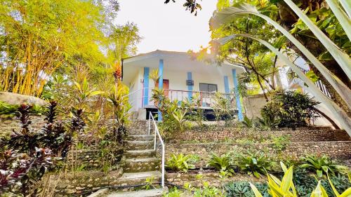 a white house with stairs in front of it at La Concepcion Cove Garden Resort in Moalboal