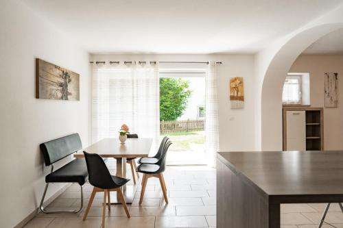a kitchen and dining room with a table and chairs at Falgerhof in Vollan