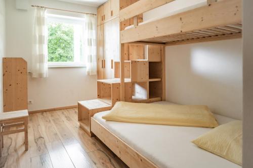 a bedroom with two bunk beds and a window at Falgerhof in Vollan