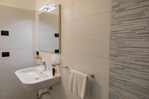 a white bathroom with a sink and a shower at Villa Lomellini in Montebello della Battaglia