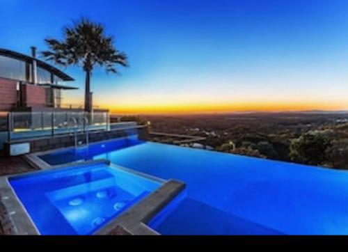 a blue swimming pool on top of a house at The Deckhouse in Boat Harbour