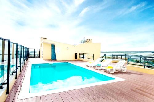 a balcony with a swimming pool on top of a building at A Gaivota Ria Formosa Waterfront Lux Apart With Pool, Olhão, Algarve in Olhão