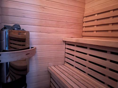 a sauna with a bench and a trash can at Quaint House Naoshima in Naoshima