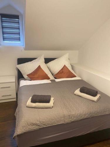 a bedroom with a bed with two pillows on it at Vila Kostic in Zlatibor