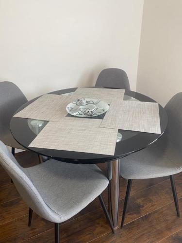 a black table with four chairs around it at Vila Kostic in Zlatibor