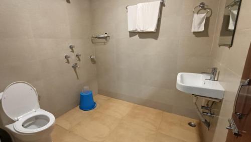 a bathroom with a toilet and a sink at Hotel Saluja in Siliguri