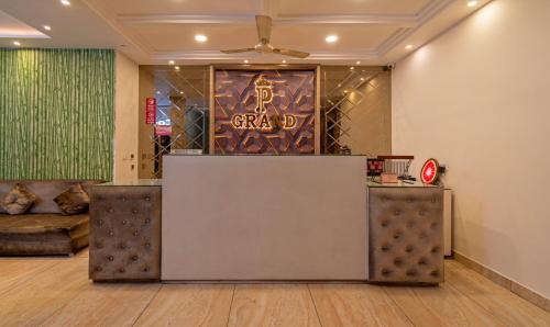 a lobby with a reception desk and a couch at Itsy By Treebo - P Grand in Ludhiana