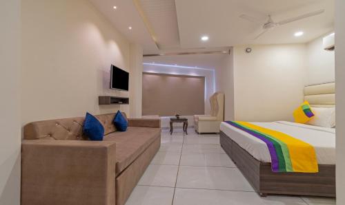 a bedroom with a bed and a couch at Itsy Hotels P Grand in Ludhiana