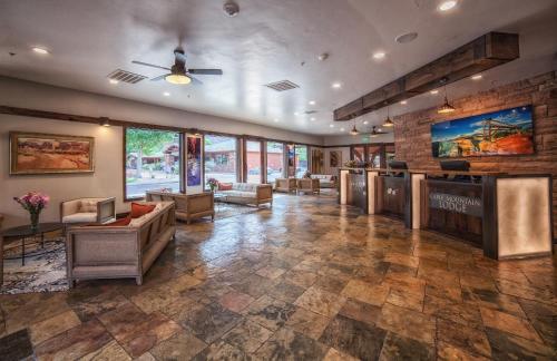 a lobby of a store with couches and chairs at Cable Mountain Lodge in Springdale