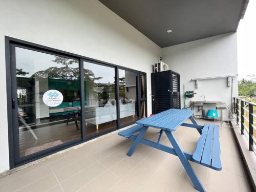 a blue bench sitting on the balcony of a house at Roxy Sematan Beach Townhouse Deluxe , 1 & 2 in Sematan