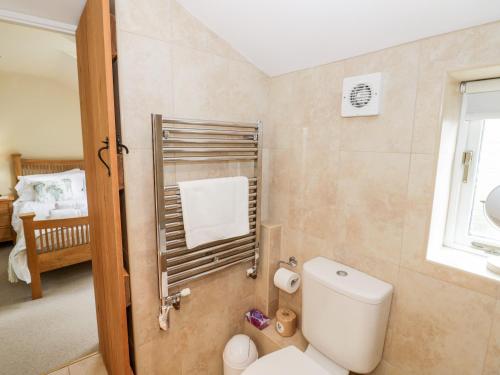 a bathroom with a white toilet and a sink at Old Bothy in Shipston-on-Stour