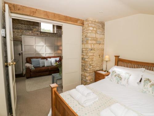a bedroom with a bed and a living room at Old Bothy in Shipston-on-Stour
