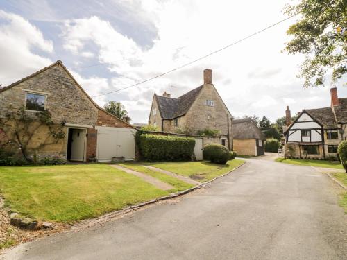 an old brick house with a driveway at Old Bothy in Shipston on Stour