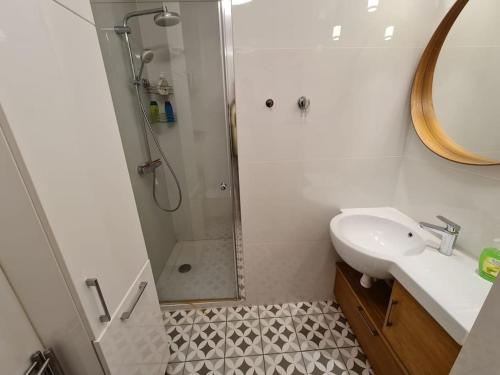 a bathroom with a sink and a shower at Fantastic Apartments - KP69 Room - A in Warsaw