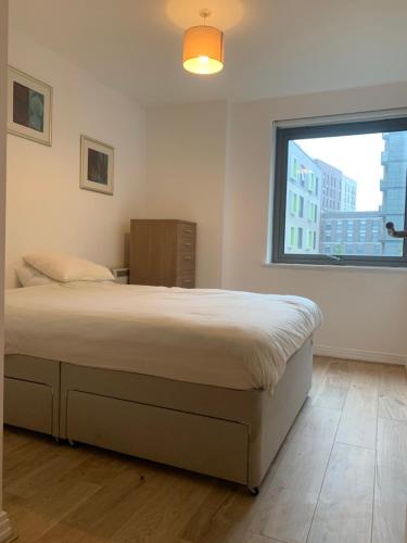 a bedroom with a large bed and a window at North Acton Flat in London