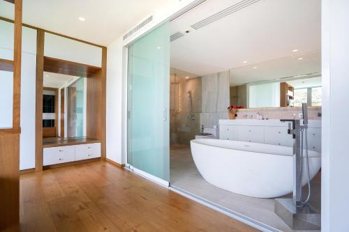 a bathroom with a large white tub and a shower at Sea View Duplex per 5 in The Blue Point 88 Residence near Patong and Paradise Beach in Patong Beach