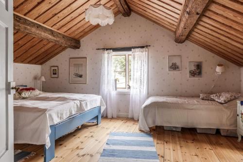 永比的住宿－Nice cottage in Bolmstad outside Ljungby，一间卧室设有两张床和窗户。