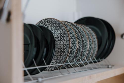 a group of plates sitting on a shelf at Pearl Apartel in Volos