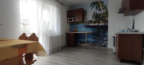 a room with a kitchen with a table and a window at DW Jastrun in Białka Tatrzanska