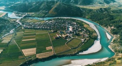 an aerial view of a village next to a river at City Center Apartment Vjosa River in Memaliaj