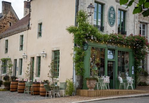 a restaurant with tables and chairs outside of a building at La Maison d'Horbé in La Perrière