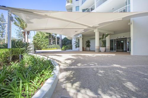 a large white building with a large white awning at Crystal Bay On The Broadwater in Gold Coast