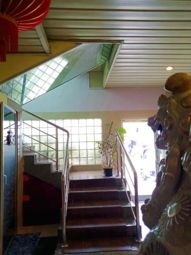 a staircase in a building with a glass ceiling at BnT Inn in Mactan