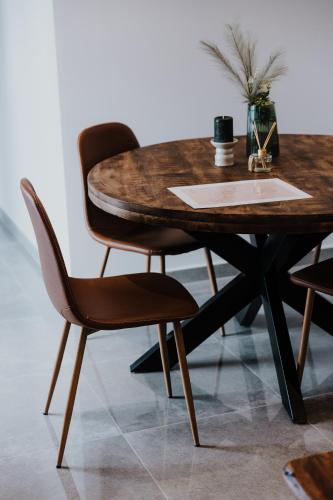 a wooden table with a wooden chair and a wooden table at Pearl Apartel in Volos
