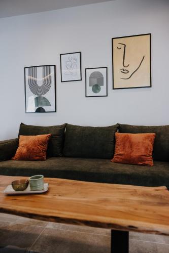 a living room with a couch and a table at Pearl Apartel in Volos