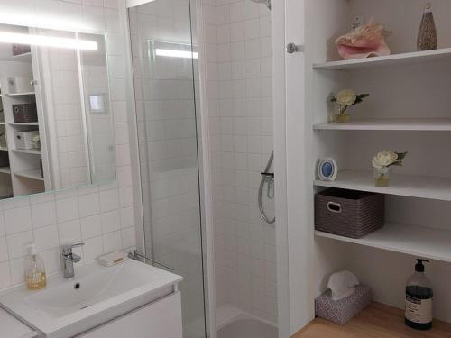 une salle de bain blanche avec une douche et un lavabo dans l'établissement Arcachon, Ville de Printemps - Appartement T2 avec Jardin à 250m des Plages - FR-1-433-91, à Arcachon