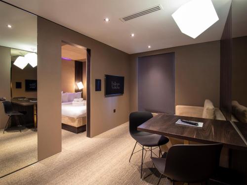 a hotel room with a bed and a table and chairs at Bloc Hotel Birmingham in Birmingham