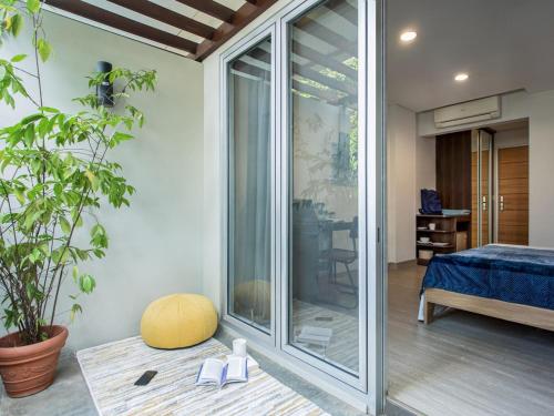 a room with a sliding glass door and a bedroom at Cove Birah Senopati in Jakarta