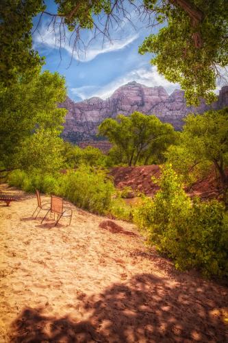 two chairs sitting in the sand in the grand canyon at Cable Mountain Lodge in Springdale
