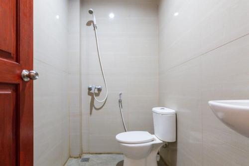a bathroom with a toilet and a shower at RedDoorz @ Raya Ngagel 2 in Surabaya