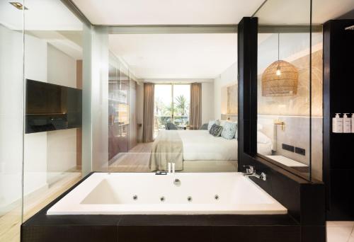 a bath tub in a room with a bedroom at Sir Anthony in Playa de las Americas